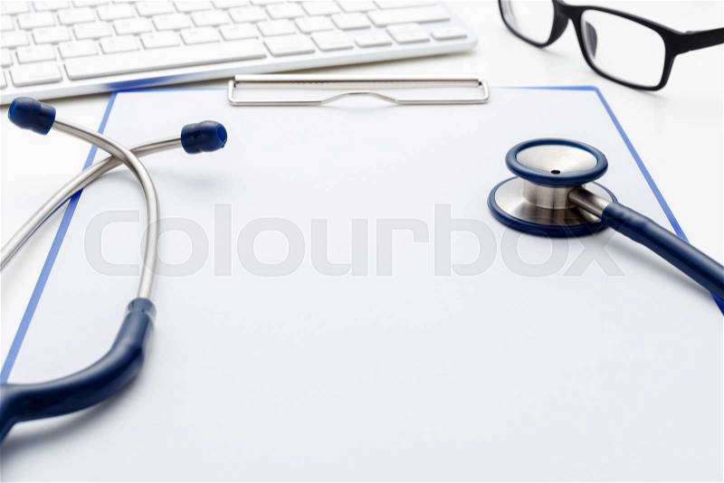 Medical stethoscope on clipboard with blank paper and keyboard, stock photo