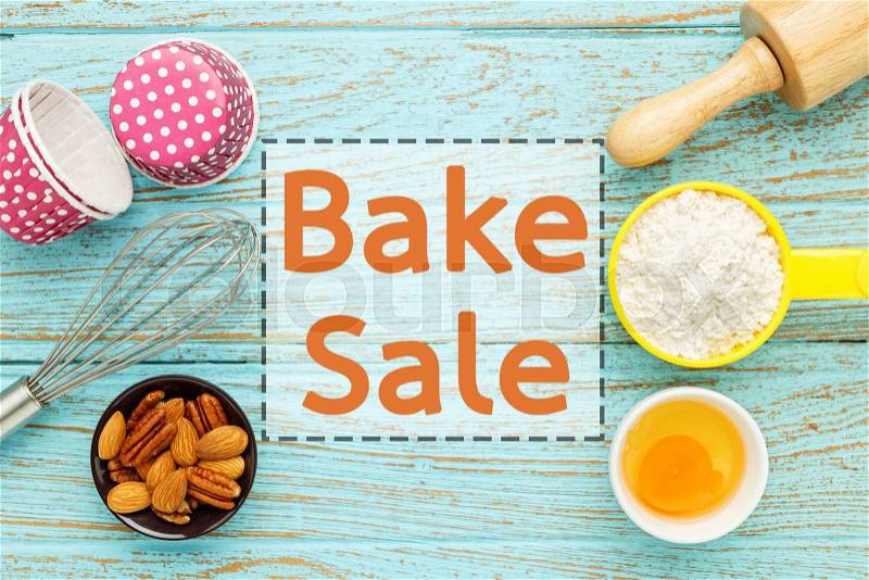 Bake sale background with baking ingredients on wood table, stock photo