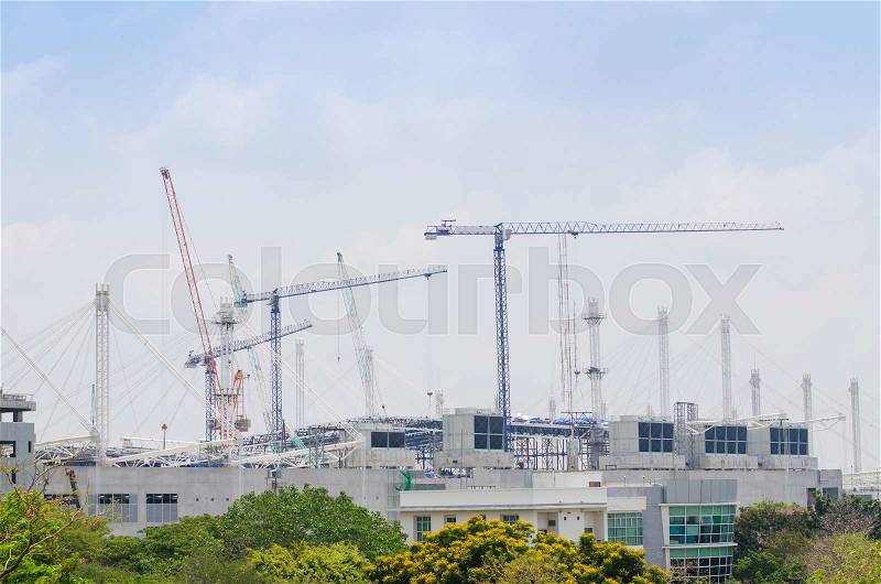 Mega construction site and cranes against blue sky, stock photo