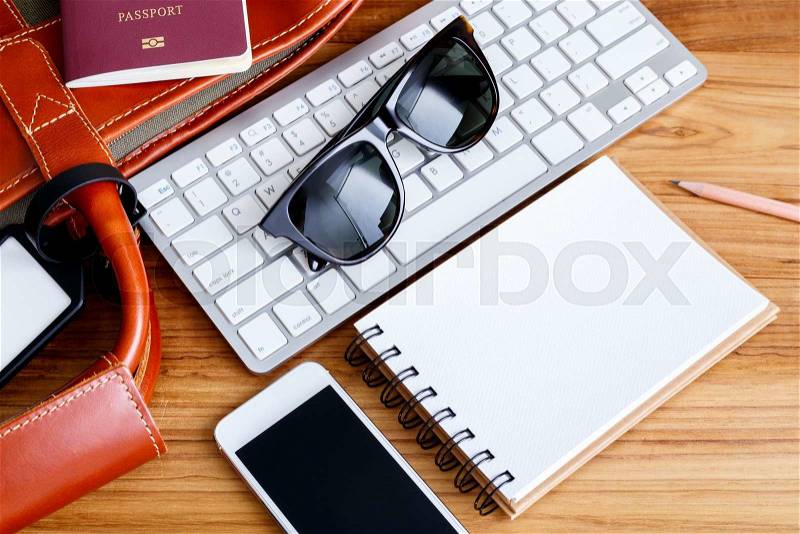 Travel booking and planning concept with bag sunglasses phone and notebook, stock photo