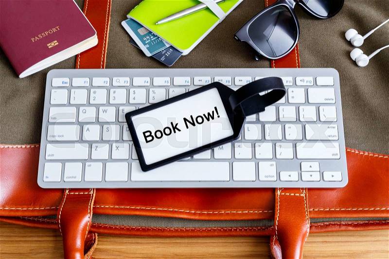 Travel booking and planning concept with bag tag and traveling accessories, stock photo