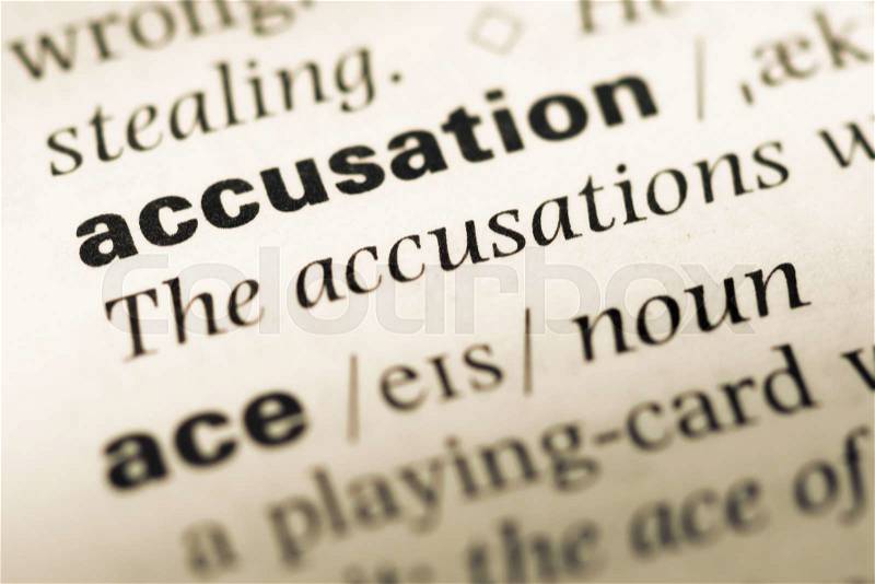 Close up of old English dictionary page with word accusation, stock photo