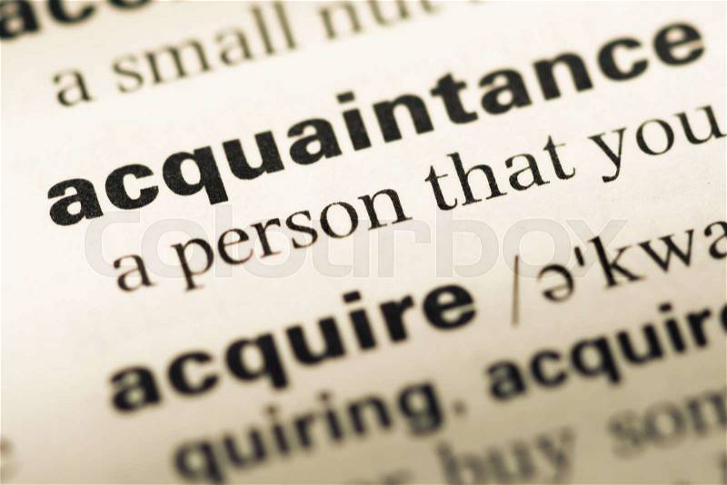 Close up of old English dictionary page with word acquaintance, stock photo