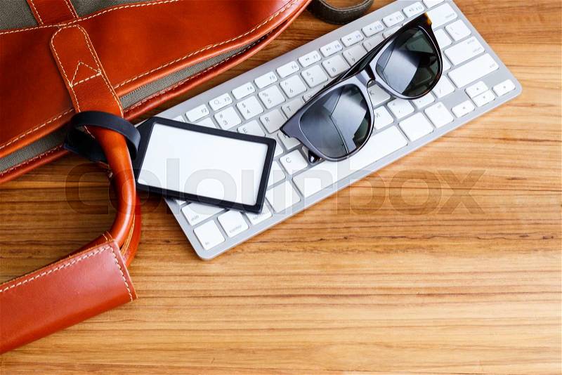 Travel booking and planning concept with blank bag tag and sunglasses, stock photo