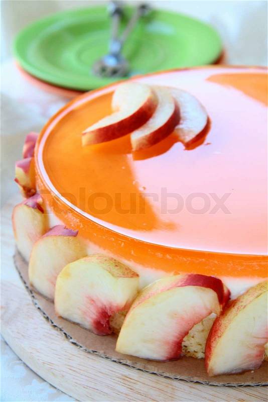 Peach cake with jelly and yoghurt on a plate, stock photo