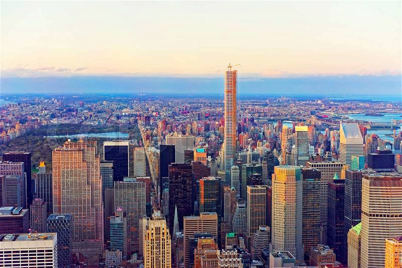 Aerial view from Observatory deck of the Empire State Building on Midtown Manhattan and Central Park, New York, USA. Skyline with skyscrapers at sunset, stock photo