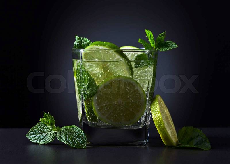 cocktail with lime , ice and peppermint leaves , stock photo
