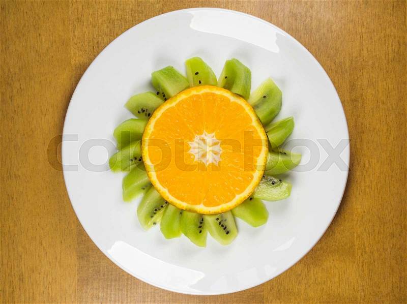 Dish of Funny flower made of oranges and kiwi, stock photo