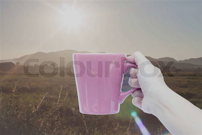 Woman hand holding coffee cup with sunrise, stock photo, stock photo