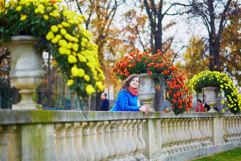 Beautiful young girl in the Luxembourg garden of Paris on a fall day, stock photo