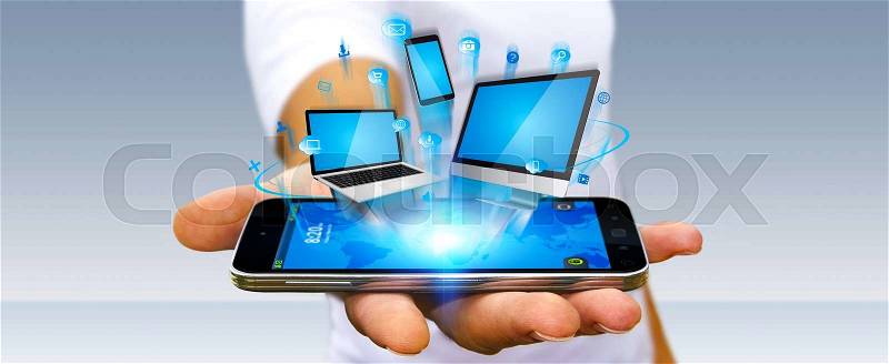 Businessman with tech devices computer phone and tablet in his hand, stock photo
