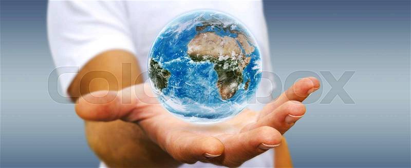 Young man holding the blue planet earth in his hand, stock photo