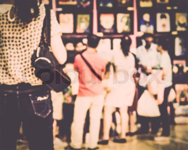 Blurred crowd of people watching art exhibition in the hall for background, stock photo