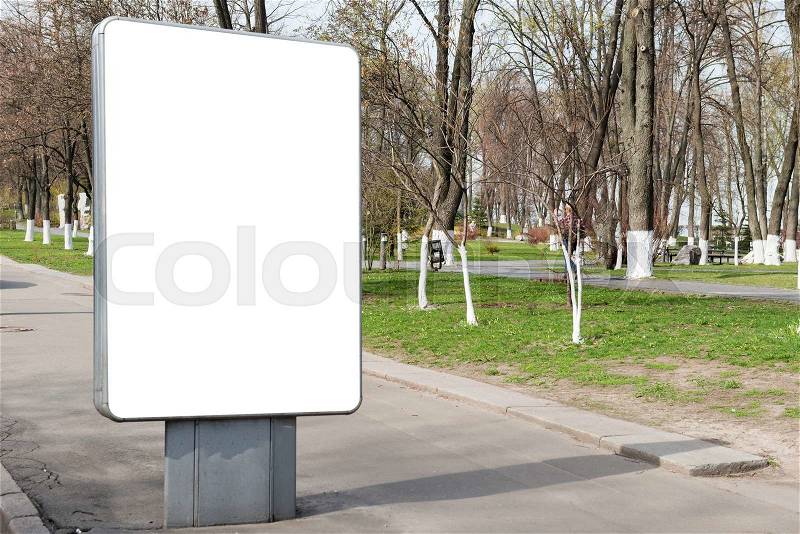 Empty billboard or lightbox on green city street with white isolated background, stock photo