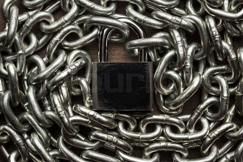 Check-lock and chain on wooden background concept, stock photo