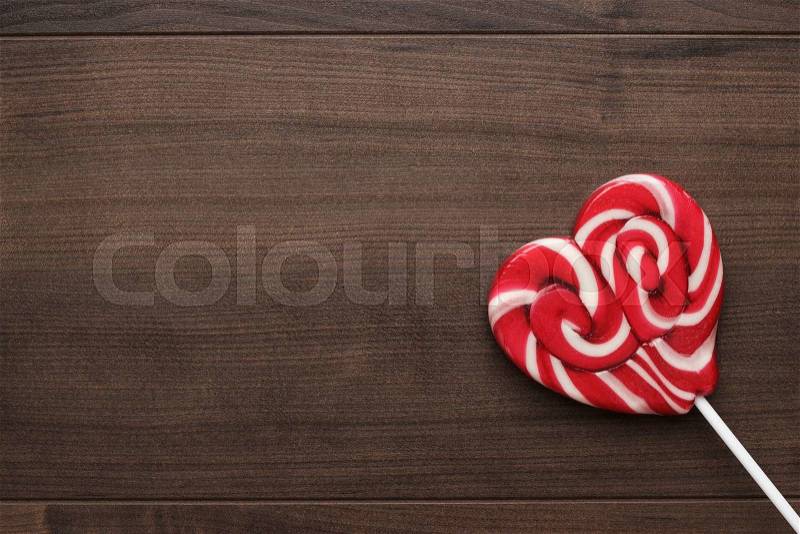Red sugar lollipop on the wooden table, stock photo