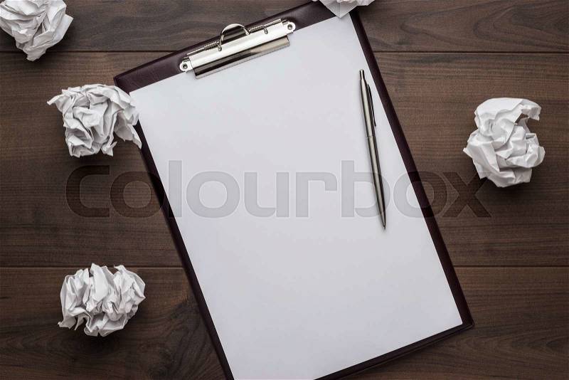 Blank sheet of paper on the white table with a pen creative process concept, stock photo