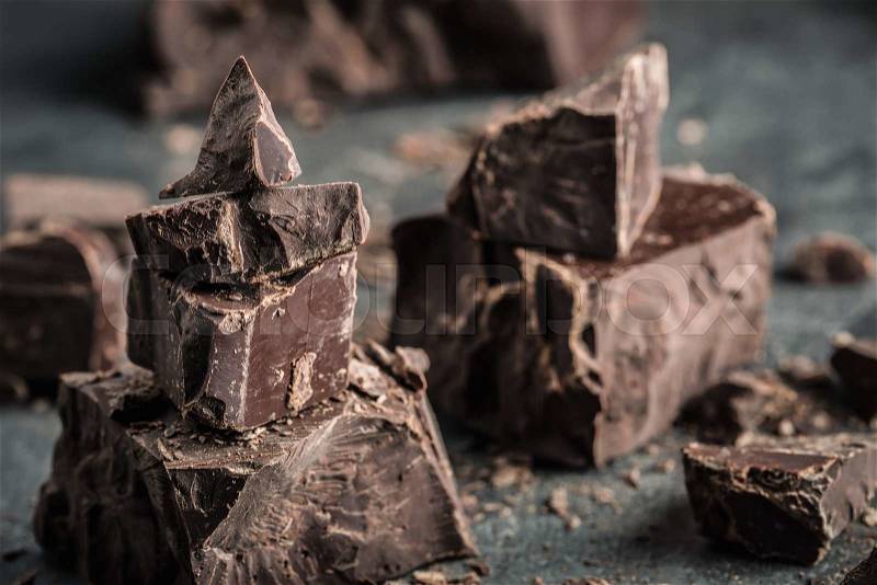 Chocolate. Black chocolate. A few cubes of black chocolate. Chocolate chunks. Chocolate bar pieces, stock photo
