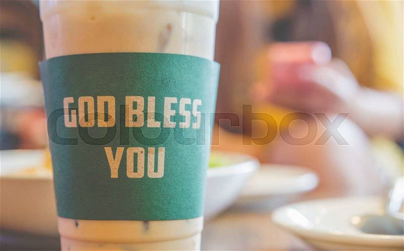 Iced coffee god bless you with milk is on the table, stock photo