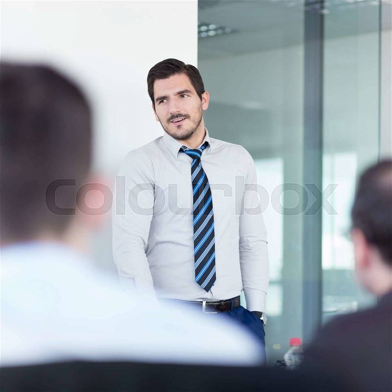 Relaxed team leader and business owner leading informal in-house business meeting. Business and entrepreneurship concept, stock photo