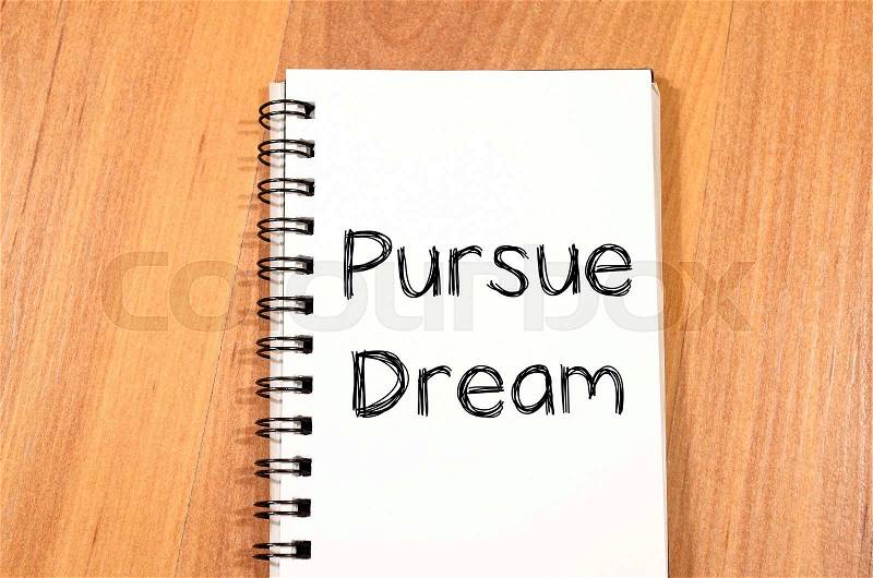 Pursue dream text concept write on notebook, stock photo