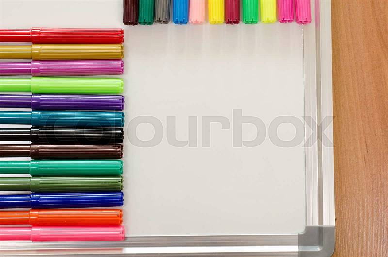Felt-tip pen and whiteboard on a wooden background, stock photo