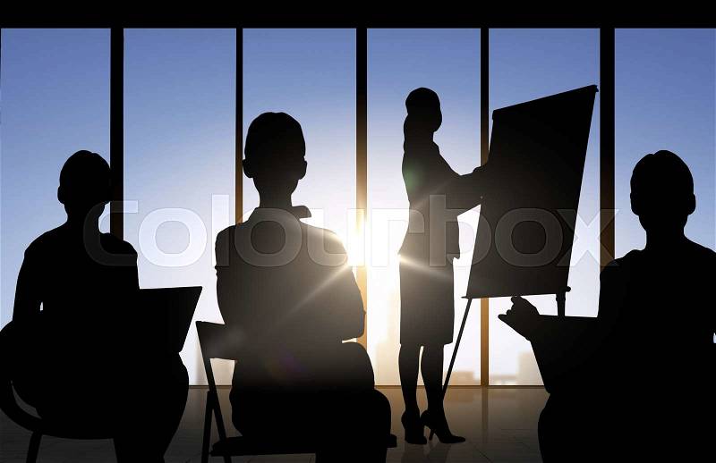 Business, strategy, planning, development and people concept - business people silhouettes at meeting or conference over office background, stock photo
