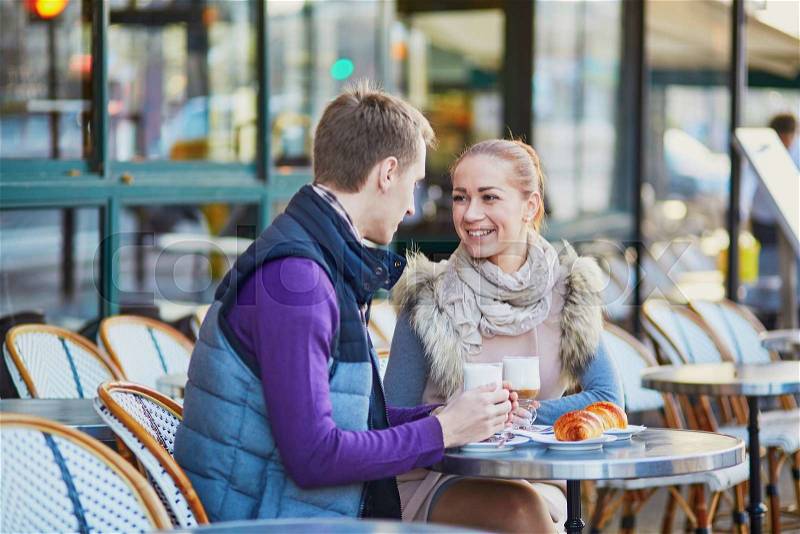 Young romantic couple in cafe in Paris, France, stock photo