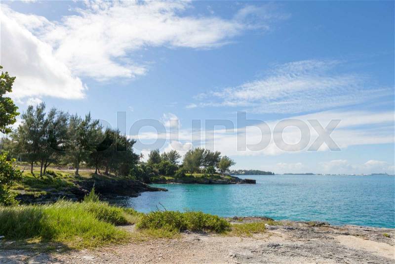 Bermuda coast with aqua blue tropical waters and rock formations complete with small caves, stock photo