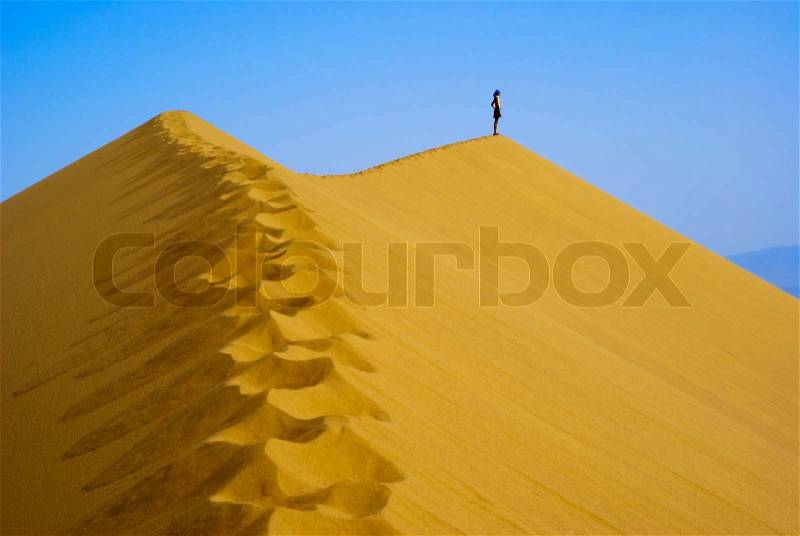 Man on top Sand Dune, stock photo