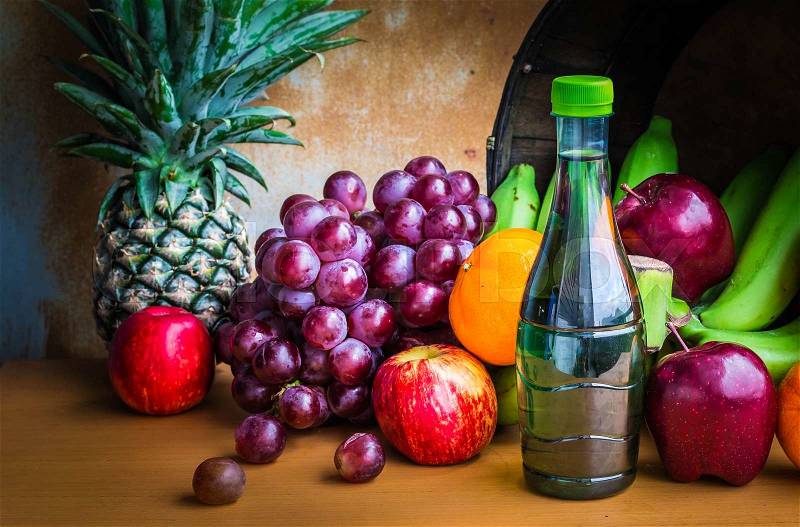 Bottles of juice and fruits fresh from the garden set on a wooden, stock photo