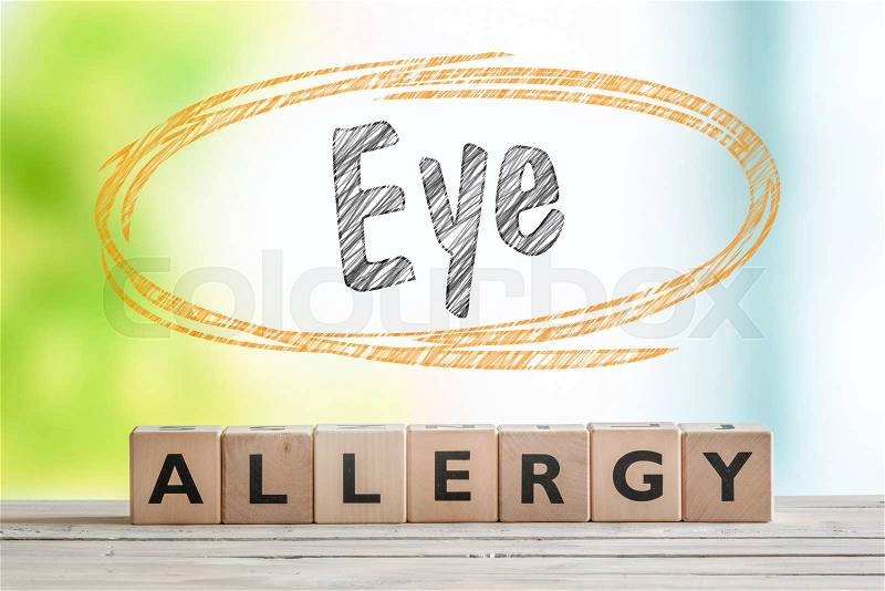 Eye allergy headline in an indoor environment with a green background, stock photo