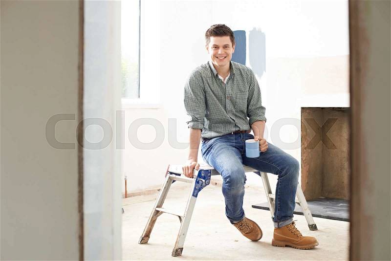 Man Sitting In Property Being Renovated, stock photo