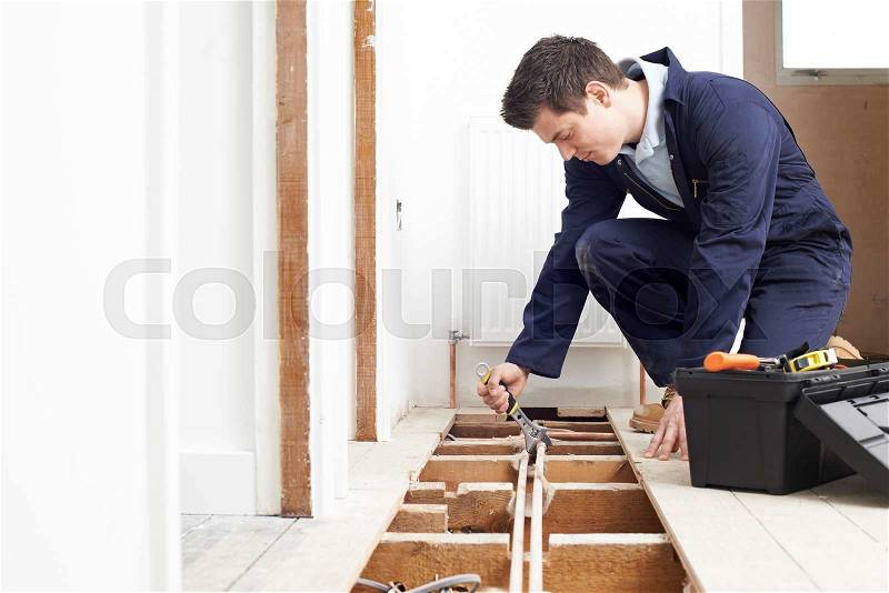 Male Plumber Fitting Central Heating System, stock photo