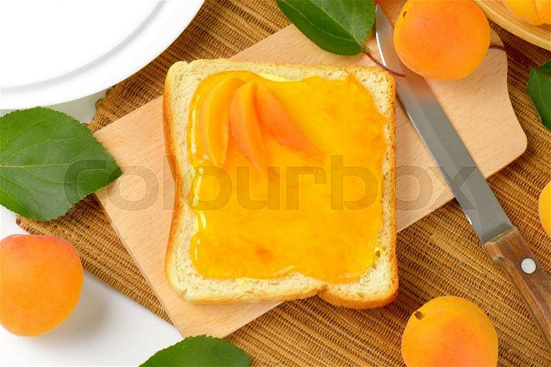 Slice of white bread with apricot jam, stock photo