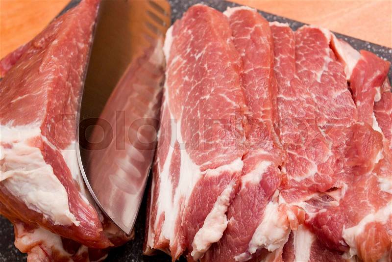 Sliced raw meat of pork on a cutting board, stock photo