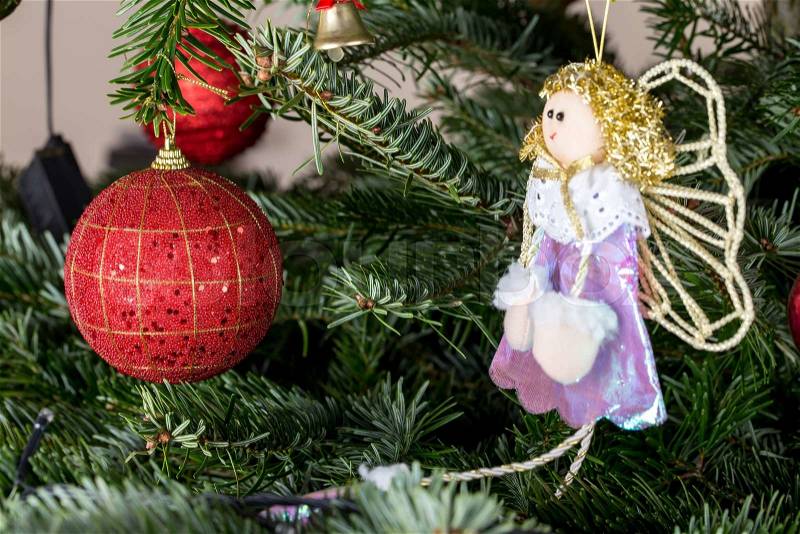 Christmas ball and beautiful fairy doll on pine tree. Macro. Can be used as a whole background, stock photo
