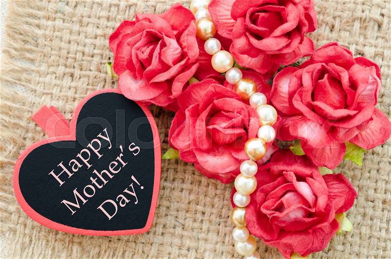 Happy Mothers day card with red roses on sack background, stock photo