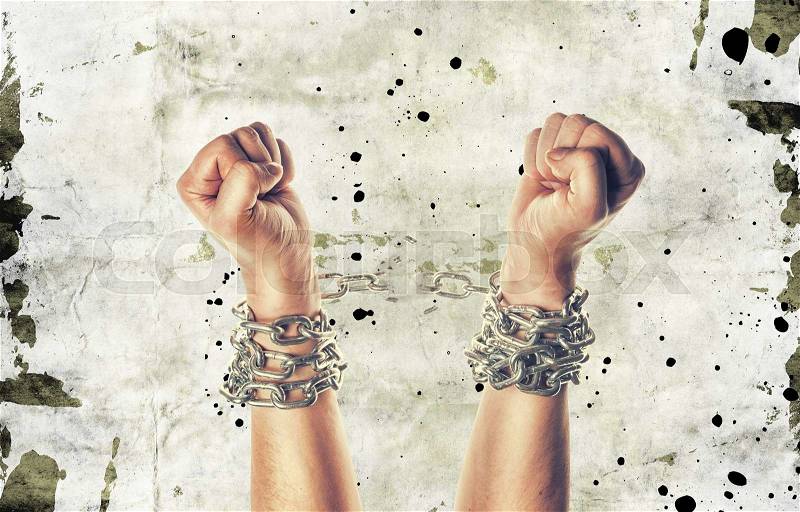 Two hands in chains on a grunge background with scratches, stock photo