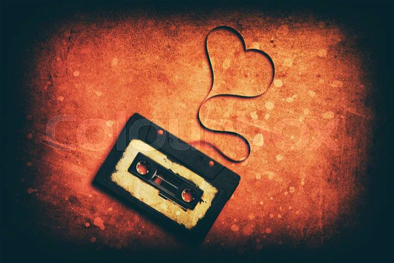 Audio cassette with magnetic tape in shape of heart, stock photo