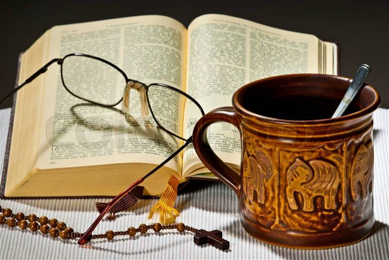 Still life with cup of tea and open bible, stock photo