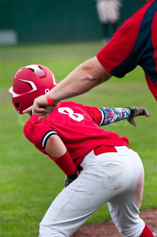 Youth baseball player getting ready to steal, stock photo