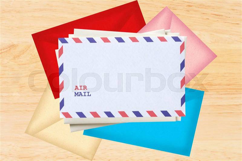 Color letters envelopes over wooden texture, stock photo