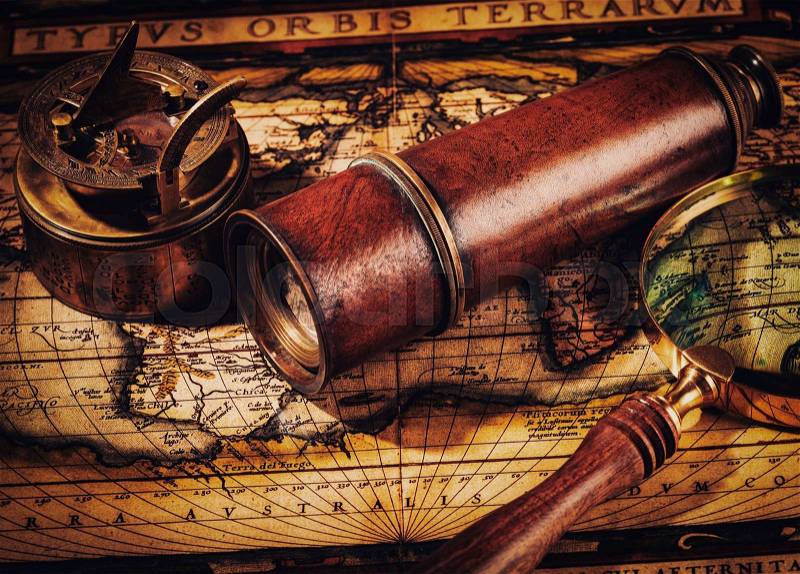 Travel geography navigation concept background - vintage retro effect filtered hipster style image of old vintage retro compass with sundial, spyglass and magnifying glass on ancient world map, stock photo