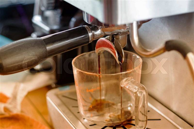 Closeup of espresso pouring from coffee machine ,Coffee making process from automatic coffee machine, stock photo
