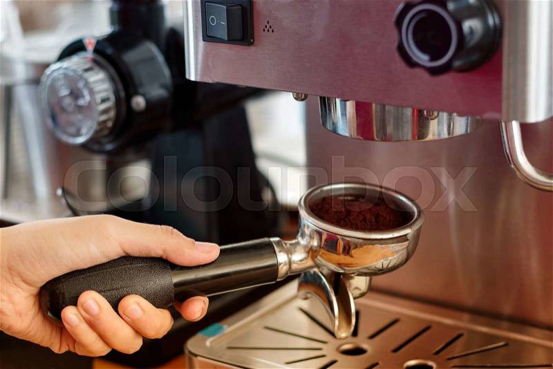 Barista preparing coffee in a cafe. coffee making process from automatic coffee machine, stock photo