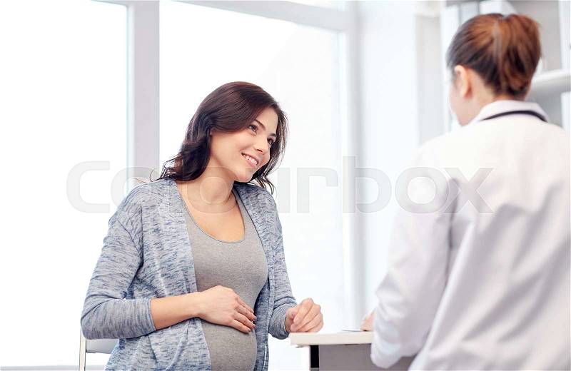 Pregnancy, gynecology, medicine, health care and people concept - gynecologist doctor and pregnant woman meeting at hospital, stock photo