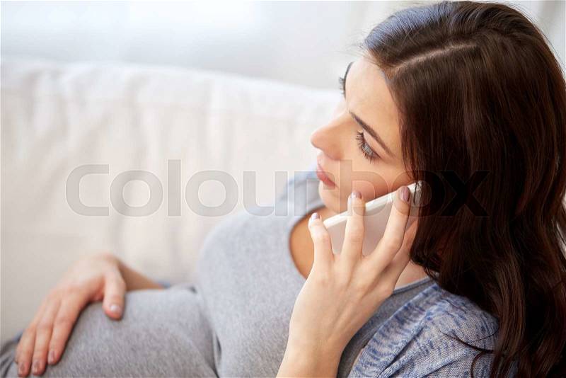 Pregnancy, motherhood, technology, people and expectation concept - sad pregnant woman calling on smartphone at home, stock photo