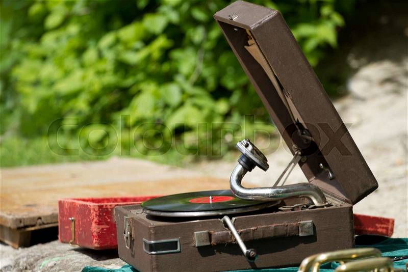 Vintage gramophone with vinyl plate on the street, stock photo