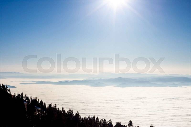 View on sun and mountains blue sky above clouds, stock photo